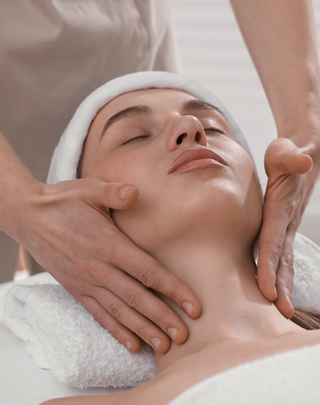 Преміальні Wellness-процедури для відновлення сил у Noelle Молода жінка відпочиває на сеансі професійного велнес-масажу у Noelle